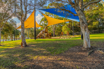 colourful Kids park with swings and slides yellow and blue shades in Suburban western Sydney NSW Australia