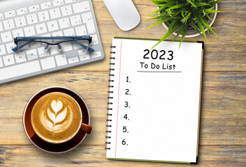 2023 to do list,Flat lay top view of laptop keyboard with coffee cup