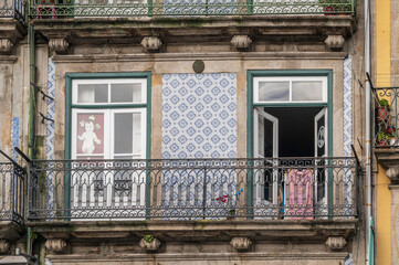 A typical window and balcony of a flat in the ancient city of Porto, Portugal