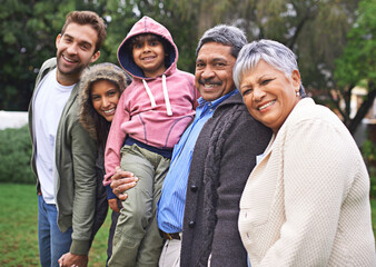 Portrait, happy and big family together in nature at garden for bonding, relationship or love at...