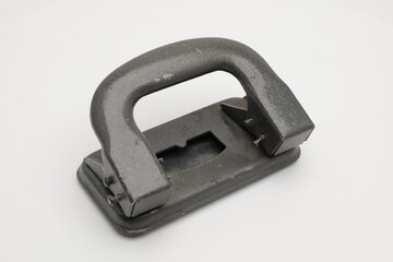 Stationery old hole punch on a white background.