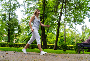 Nordic walking - woman exercising in city park
- 765604386