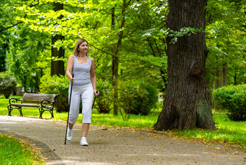 Nordic walking - woman exercising in city park
- 765604394