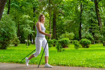 Nordic walking - woman exercising in city park
- 765604512