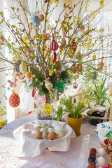 Easter eggs on willow branches in a vase.