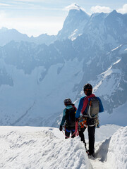 Couple of experienced mountaineers ascending Mont Blanc on sunny day, Chamonix, France