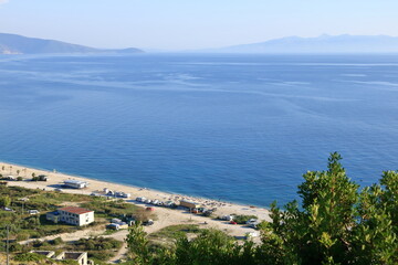 Obraz premium Aerial view of Borshit beach. Qazim Pali cityscape. Colorful seascape of Adriatic sea, Albania