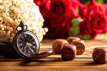 Antique clock and accessories, old and beautiful clock and accessories on rustic wood and dark background, selective focus.