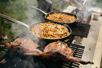 chef cooking outside summer grill party chanterelles and chicken