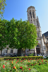 Paris, France. Tulips blooming in the park "Square Michel-Caldagu&egrave;s" and the church "Saint-Germain l'Auxerrois". March 26, 2022.