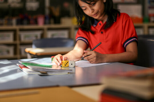Student using dice to solve maths problems