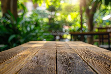 Zelfklevend Fotobehang Wooden table perspective blurred greenery background © agnes
