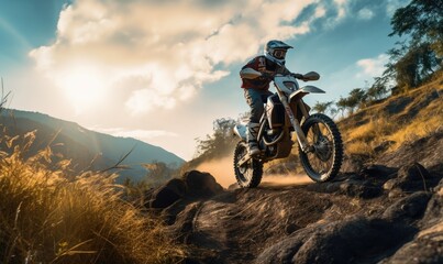 Back view of man riding a off-road motorcycle, going up to steep cliff.