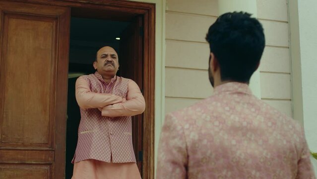 Indian Father in Traditional Clothing looking at the visitor with disapproval