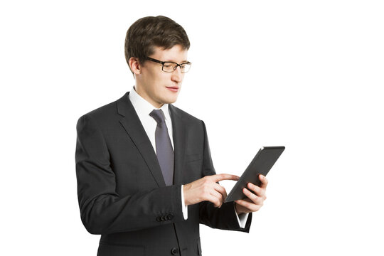 A businessman in a suit using a digital tablet, isolated on a white background, depicting modern technology in a work context