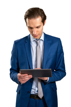 A young businessman in a blue suit using a tablet, isolated on a white background, depicting modern technology use in business