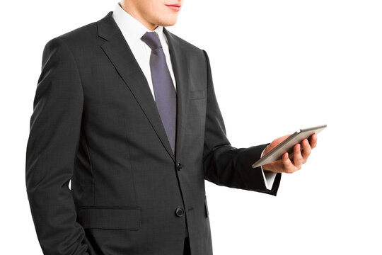 A businessman in a suit using a digital tablet, photographed closeup with a white isolated background, focusing on modern technology in business
