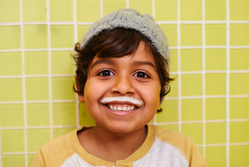 Milk moustache, smile or boy portrait in house with healthy breakfast drink on yellow wall...