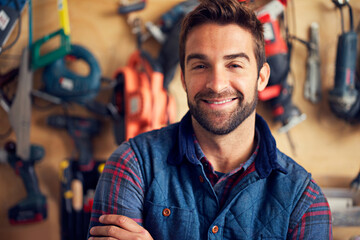 Carpenter, portrait and happy man in workshop for diy, home development or building renovation....