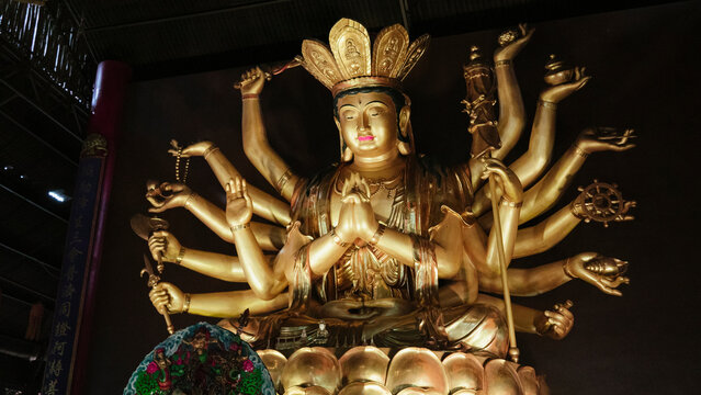 Golden sculpture of Avalokiteshvara Buddha or Guanyin with thousand hands at Putuo Village in Malaysia.