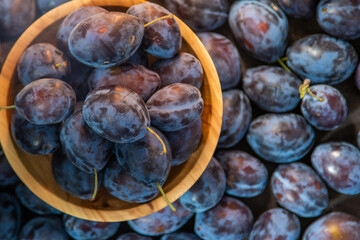Plum variety Hungarian. Fruit harvest on the table in the kitchen. Autumn blue plum. Vitamin food bowl.