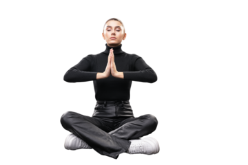 A young woman in black clothing seated in a meditative pose with hands together, isolated on white background