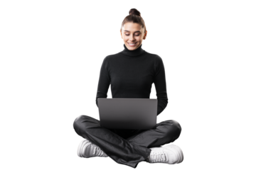 A smiling young woman sitting cross-legged with a laptop on a white background, embodying a casual business concept