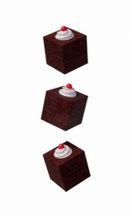 Three floating chocolate cakes on a white background