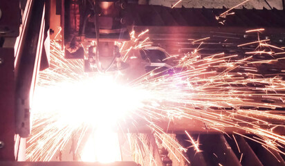 Sparks flying when cutting metal on machine. Metal Products Plant