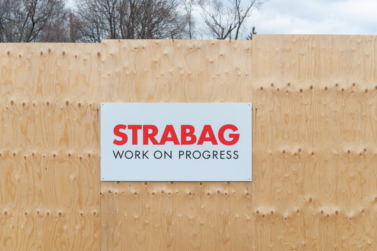 plywood hoarding and sign of STRABAG, an international company specializing in tunnelling (Eglinton Crosstown Expansion, in Toronto, Canada)