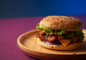 Burger served on a wooden plate with lettuce, onion, and tomato. social media post, food photography, fine dining, purple background, restaurant menu, fast food, junk food, street food, delicious
