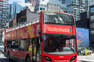 Fototapeta premium City Sight Seeing tour bus heading west on Queen Street West in Toronto, Canada