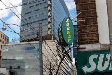Fototapeta premium projecting sign outside Subway, a sandwich shop chain, located here at 267 Queen Street West in Toronto, Canada