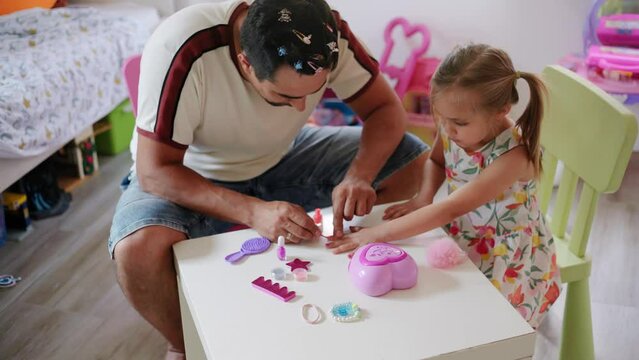Daughter and father role-playing manicure salon