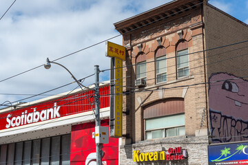 Fototapeta premium exterior building and sign of Scotiabank branch located at 222 Queen Street West in Toronto, Canada (also Korean Grill House located at 214 Queen)