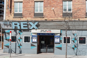 Fototapeta premium exterior building facade entrance and sign of The Rex Hotel Jazz and Blues Bar located at 194 Queen Street West in Toronto, Canada