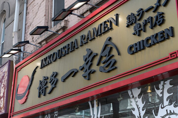 Fototapeta premium exterior building and sign of Ikkousha Ramen Chicken, a Japanese restaurant, located at 257 Queen Street West in Toronto, Canada