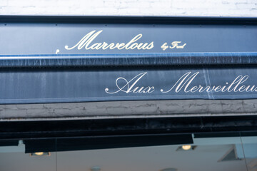 Fototapeta premium exterior awning signs at Aux Merveilleux de Fred, a pastry shop, located at 224 Queen Street West in Toronto, Canada