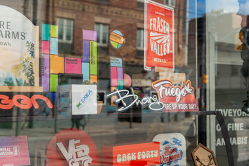 Fototapeta premium cannabis shop window display with brand logos on Queen Street West in Toronto, Canada