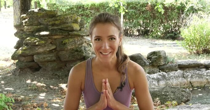 Beautiful girl - yogi in a training video about yoga