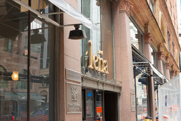 Fototapeta premium exterior building facade and sign of Leña Restaurante, a Latin American restaurant, located at 176 Yonge Street in Toronto, Canada