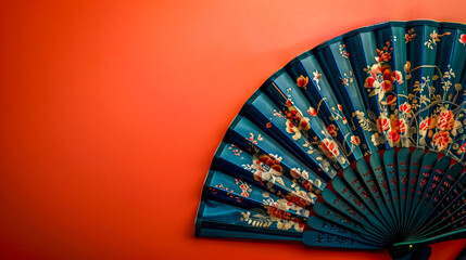 Traditional asian fan on vibrant red background