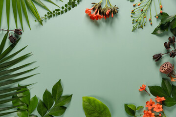 Composition made of meadow flowers and leaves on green background. Flat lay. View from above