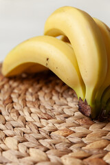 Closeup of bunch Organic bananas on a wicker background. Selective soft focus - 765696155