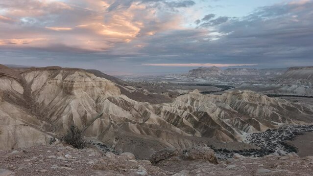 Bright Desert mountains and clouds in time lapse during colorful and dramatic sunset in winter, Panoramic, in Sde boker, Zin stream, Negev, Israel