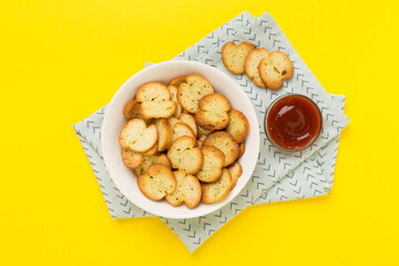 Spiced bruschette chips on color background, top view