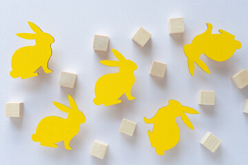 decorative easter bunnies painted yellow and wood cubes on paper