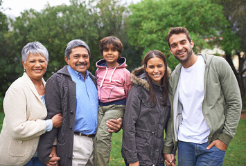 Portrait, smile and big family in nature outdoor for bonding, relationship and holding hands at...