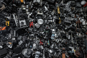 heap of old vintage film cameras and retro lenses, creative abstract photography and filmmaking...