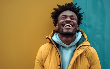 Fototapeta premium A man with a yellow hoodie is smiling and laughing
